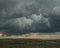 A huge cumulonimbus storm cloud over the steppe expanses.