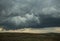 A huge cumulonimbus storm cloud over the steppe expanses.