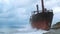 A huge dry cargo ship rio aground on a stone beach