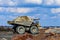 Huge dump truck loaded with iron ore on a gravel road