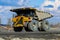 Huge empty dump truck on a gravel road