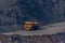 Huge empty dump truck on a gravel road in iron ore quarry