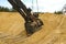 Huge excavator bucket digs sand in sand quarry mining