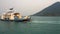 A huge ferry with people departs from the island.