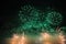 Huge fireworks in the sky with green sparks