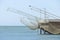 Huge fishing nets are suspended over the sea