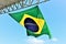 A huge flag of Brazil blowing in the wind at sunny day