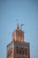 Huge flock of storks flying around the minaret of the Koutoubia mosque in the medina of Marrakech, Morocco. Captured