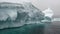 Huge giant iceberg and ice floe in ocean of Antarctica.