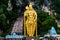 Huge gold statue of hindu god hanuman at entrance of batu caves during cloudy day in kuala lumpur malaysiahuge blue statue of hind