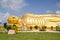 Huge golden sleeping Buddha with blue sky