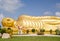 Huge golden sleeping Buddha with blue sky