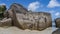 Huge granite boulders with smoothed folded slopes on a sandy beach