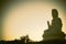 The huge Guan yin statue on the peak hill in silhouette sunset. Famous Chinese Buddha statue.