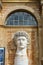 Huge head of young male sculptured in marble stone.