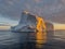 A huge high breakaway glacier drifts in the southern ocean off the coast of Antarctica at sunset, the Antarctic