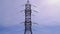 Huge high-voltage electrical pylons against a blue sky