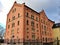 Huge historical granary building with red facade