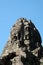 A huge human face built of stone blocks. Huge human faces on the towers of the Bayon temple in Cambodia. Architectural art of
