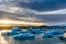 Huge icebergs in a beautiful glacial melt water lagoon with a colorful sunset sky Iceland