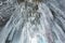 Huge icicles in the ice grotto on Lake Baikal in winter