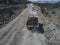 Huge industrial dump truck in a stone quarry from drone top shot