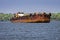 Huge Iron ore transporting barge passing through backwaters of Goa