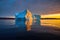 huge, isolated iceberg glittering in the low midnight sun