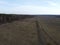 Huge lifeless wasteland, top view. Edge of a leafless spring forest. Landscape