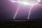 Huge lightning strikes the forest and field