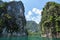 Huge limestone cliffs rising out of open lake at Khao Sok Nation