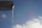 Huge long icicle hang on a drainpipe in blue sky background