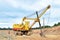 Huge mining excavator in the limestone open-pit. Biggest digger working in dolomite quarry. Largest tracked machine with electric