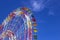Huge modern colorful bright ferris wheel in an amusement