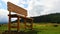 Huge monumental wooden bench as symbol of relax, placed in beautiful upland landscape