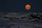 Huge moon in the night sky over one of the Antarctic