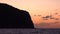 Huge mountain, Mediterranean sea and colorful sky with gray clouds. Lipari Islands, Sicily, Italy