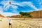 The huge multi-colored balloon flies over the hot desert