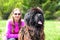 Huge Newfoundland dog detail on head with blurred woman in pin