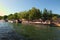 Huge number of tourists and floating restaurant on old barge, quays bistro at sunny day. View from the tourist boat. Paris, France