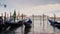 A huge ocean liner sails in the Bay of Venice, the gondolas rock on the waves in the foreground