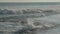 Huge ocean waves roll on beach against blue sky slow motion