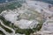 Huge open-pit granite quarry, view from drone, cloudy day