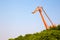 Huge orange crane in front of blue sky