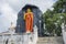 Huge orange statue of Buddha in the yard of temple