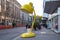 Huge oversized yellow table lamp standing in street of Karlsruhe as part of project called `Spot on!` to show city development