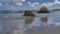 Huge picturesque boulders in the surf on a tropical beach.