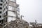 A huge pile of gray concrete debris from piles and stones of the destroyed building. Copy space