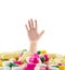 A huge pile of various pills with a man\'s hand