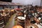 Huge piles of car wheels and wrecked cars at a junkyard